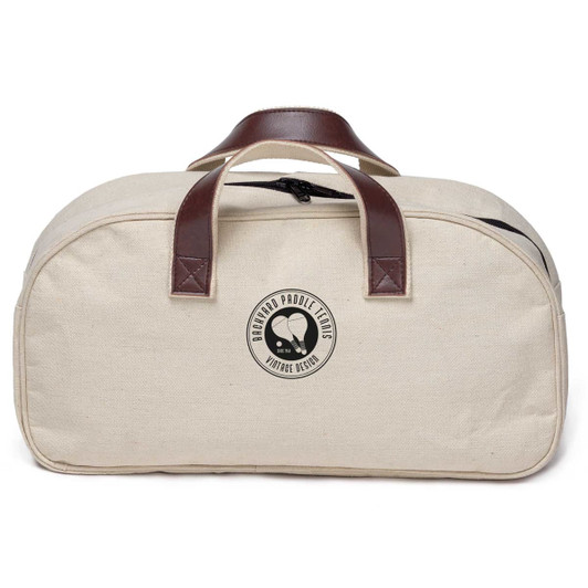 A cream-coloured bag with brown leather handles and a logo on the front. The bag has a zipper closure.