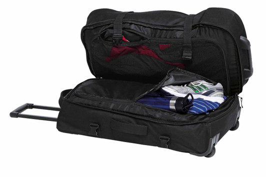 A black wheeled travel bag with multiple compartments, featuring sports shoes, a drink bottle, and clothing inside.