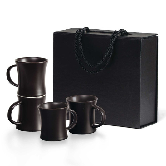 A set of four espresso mugs in dark brown stacked inside a black gift box with handles.