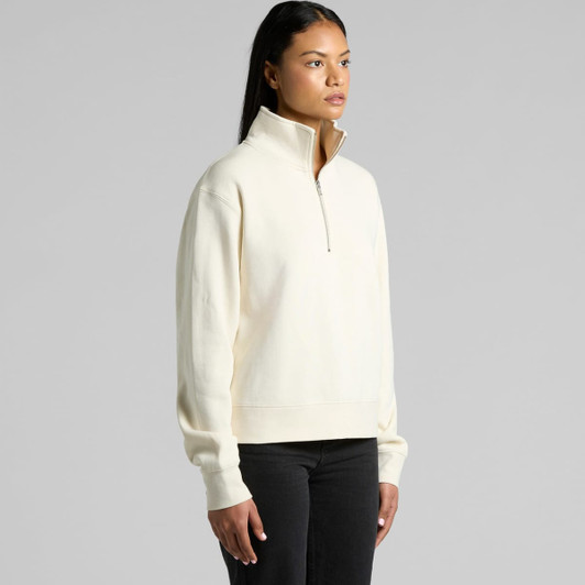 A cream-coloured half zip crew jumper with long sleeves and a relaxed fit. It features a branded logo.