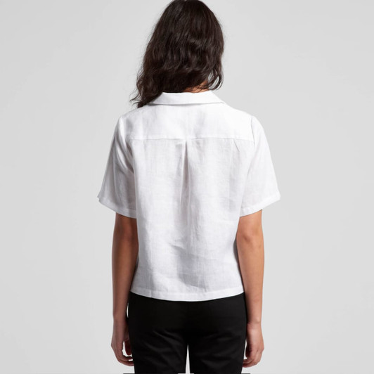 A short-sleeved white button-up shirt with a relaxed fit, featuring a collar and a back yoke detail.