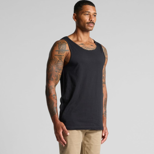 A black singlet featuring a classic tank style, displayed on a tattooed male model against a neutral background.