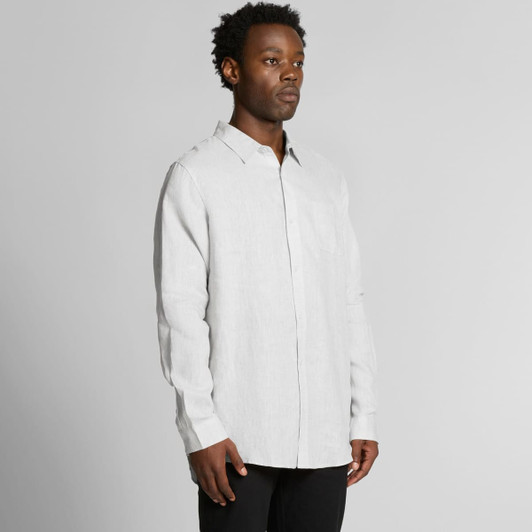 A light grey linen button-up shirt displayed on a model, featuring a chest pocket and long sleeves.