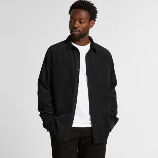 A black cord shirt with a button-up design, featuring a chest pocket and worn over a white t-shirt.