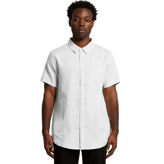 A short-sleeved linen button-up shirt in white, featuring a collar and a relaxed fit. The model stands against a plain background.