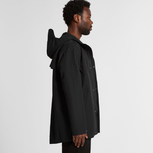 A black rain jacket with a hood, featuring a logo and a loose-fit design, showcased from the side.