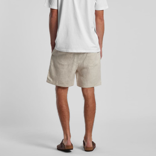 Linen shorts in a light beige colour, featuring two back pockets and a simple, casual design.
