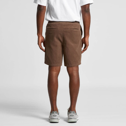 Brown cord shorts featuring a logo and back pockets, viewed from the back on a model.