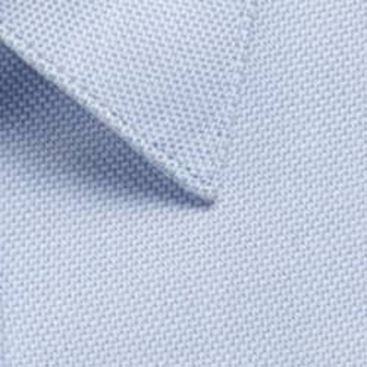 A light blue button-up shirt fabric close-up, featuring textured weave and neat collar detail.