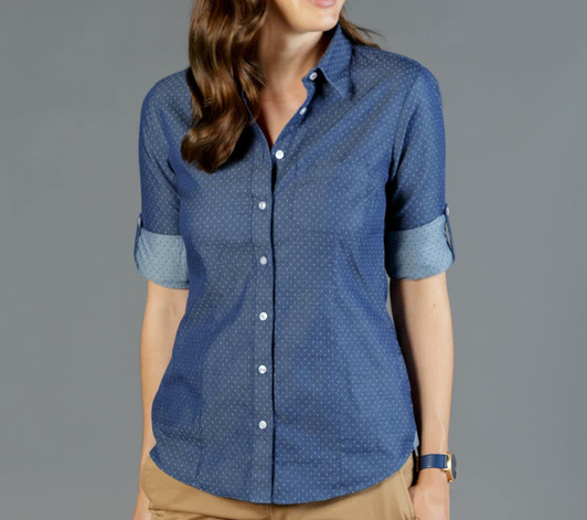 A blue button-up shirt featuring a chambray design with rolled sleeves and a subtle dotted pattern.
