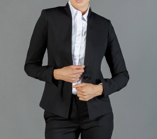 A black fitted jacket with a high collar and button closure, worn over a white shirt. Features branding.