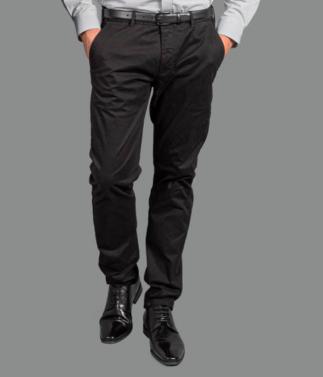 A pair of black chinos worn with a light-coloured shirt and black shoes, featuring a belt and a logo.