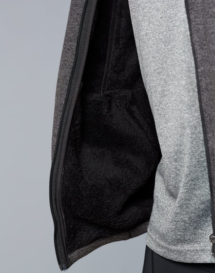 A men's grey bonded fleece jacket displaying a soft, fleece-lined interior with a pocket. It has a logo on the exterior.
