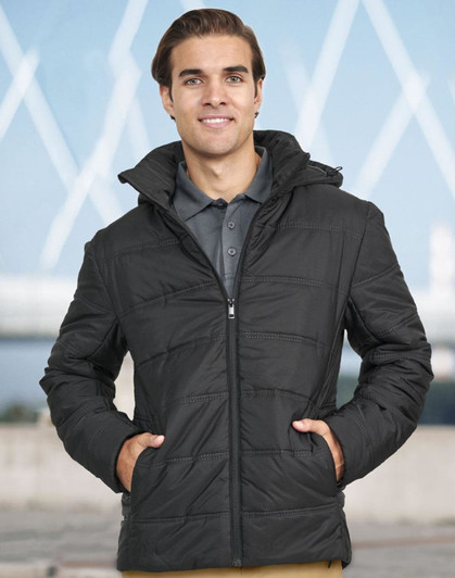 A man wearing a black unisex sustainable parka jacket with a hood, featuring a zip front and panel detailing.