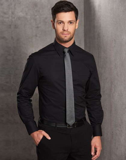 A man wears a black long-sleeve cotton/poly blend button-up shirt with a grey tie, featuring a chest pocket.