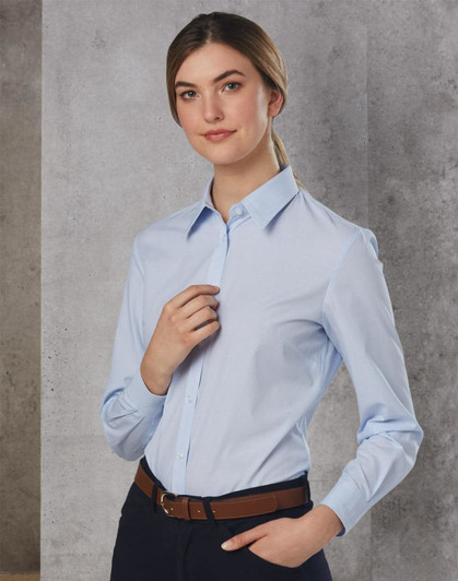 A long sleeve button-up shirt in light blue, featuring a collar and a fitted design, paired with a brown belt.