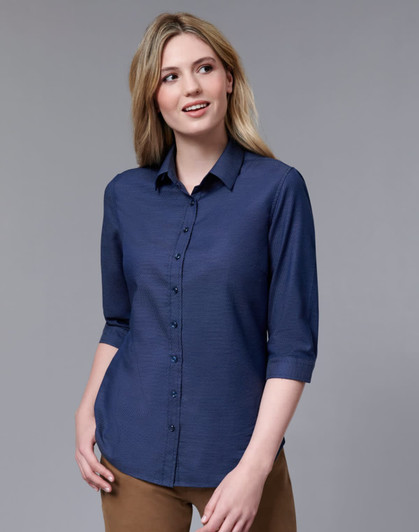 A navy button-up shirt with a pin dot pattern and 3/4 sleeves, featuring a collar and branded logo.