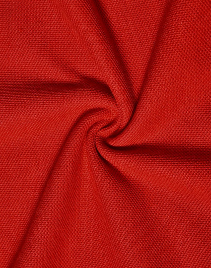 A close-up of red pique knit fabric, showcasing its texture and weave pattern. It features a smooth and breathable surface.