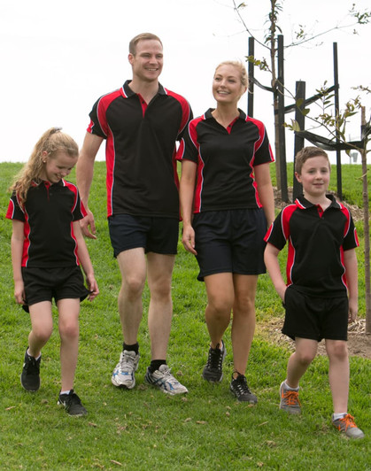 A group of four people wearing matching black and red Men's Alliance polo shirts and shorts, walking on grass.