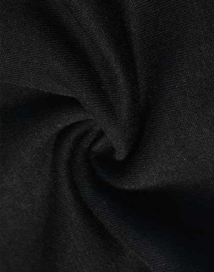 A close-up of black poly/cotton fabric, featuring a soft and smooth texture suitable for sweat pants.
