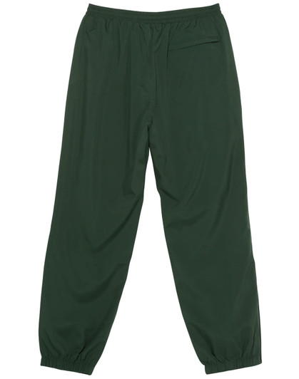 A pair of green track pants with an elastic waistband and a single pocket at the back. Features a brand logo.