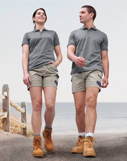 A pair of unisex cotton stretch drill short work shorts in light grey, worn by a male and female model.