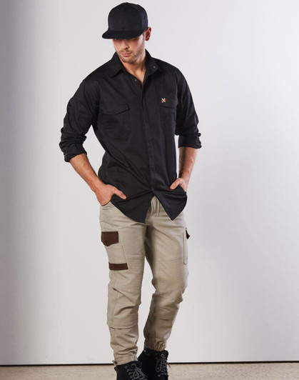 A model wearing a black long-sleeve work shirt and beige cargo pants, featuring two chest pockets and a logo.