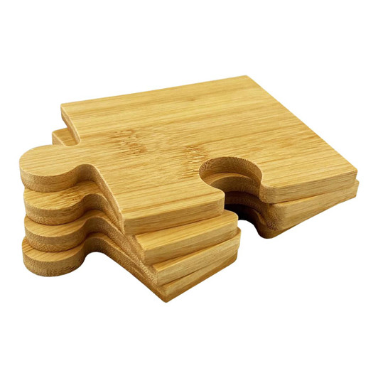 A set of bamboo coasters featuring a puzzle piece design, showcasing light brown wood tones.
