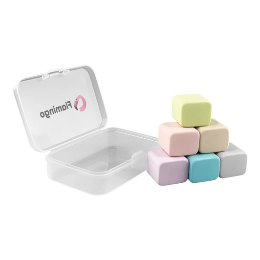 A clear box containing six pastel-coloured rubber erasers shaped like cubes. The box is partially open.