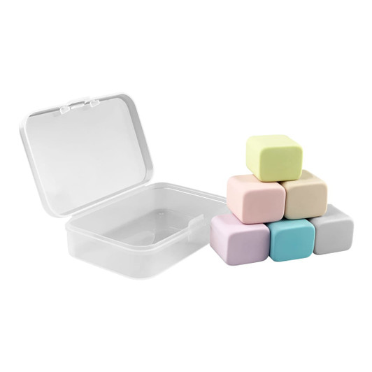 A set of six pastel-coloured rubber erasers stacked beside a clear storage box.