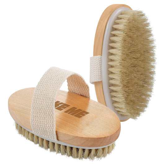 A wooden body brush with a soft bristle head and a fabric strap in a natural colour. It features a logo.