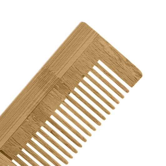 A bamboo comb in a light brown shade with wide and narrow teeth, featuring a textured handle.