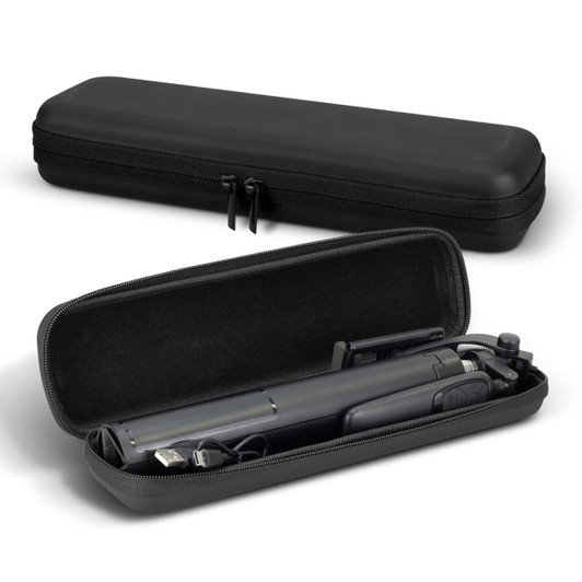 A black carry case containing a compact selfie stick tripod and various accessories inside.