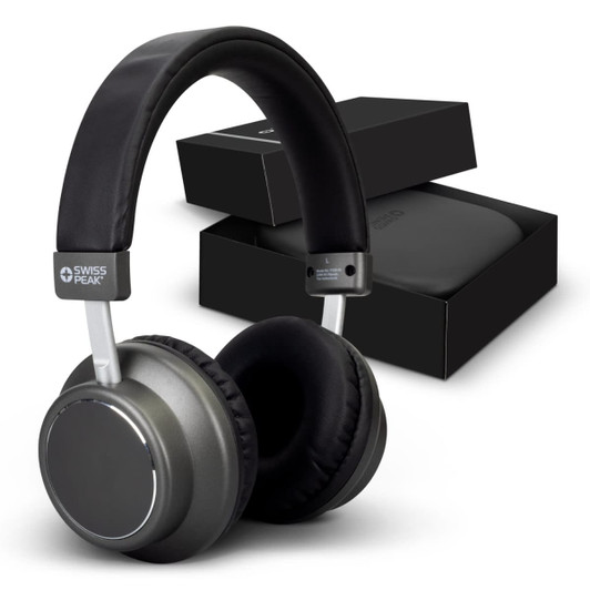A pair of grey wireless headphones with a black cushioned headband, accompanied by a black box.