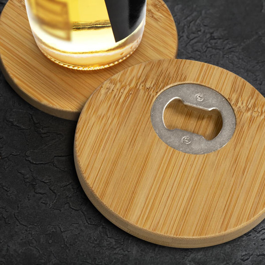 A drink bottle rests on two round bamboo coasters, each featuring a metal bottle opener in the centre.