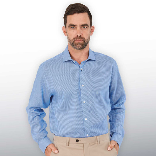 A men's button-up shirt in light blue with long sleeves and a collar, featuring a logo.