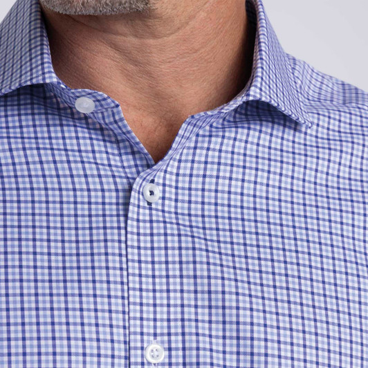 A close-up of a men's button-up shirt featuring a purple and white check pattern, with a classic collar and buttons.