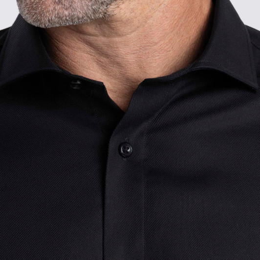 A black button-up shirt with a textured fabric and collar, featuring a logo on the design.