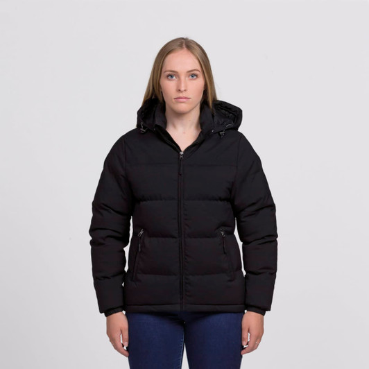 A black puffer jacket features a zip front and a hood, worn by a model with long hair.