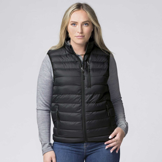 A black padded baffle vest with a zippered front and side pockets, worn over a grey long-sleeve top.