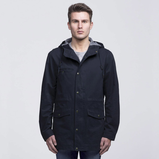 A navy blue twill jacket with a hood, featuring pockets and a grey lining, worn by a model.