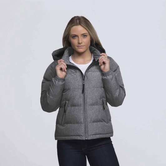 A woman wearing a grey puffer jacket with a hood, featuring a front zipper and side pockets.