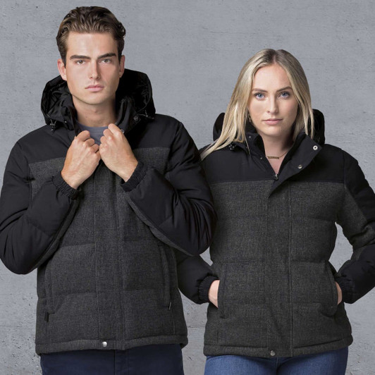 A black and grey rain jacket features a hood, with a stylish design for both men and women. It has a logo on the front.