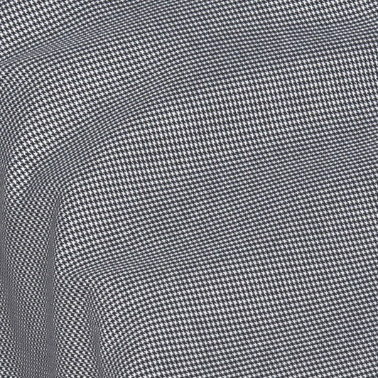 A button-up shirt featuring a black and white houndstooth pattern, with a small logo on the fabric.