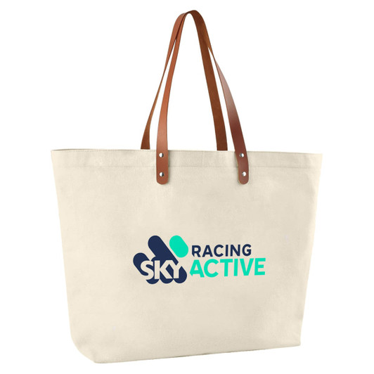 A cream cotton tote bag with brown leather handles and a logo printed on the front.