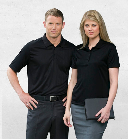 A black men's polo shirt worn by a man and a matching black polo worn by a woman, both with a subtle ribbed design.