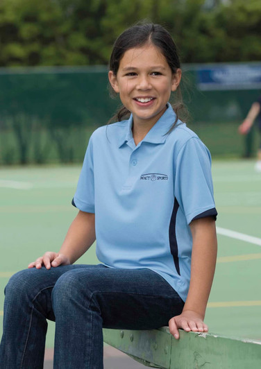 A light blue polo shirt with dark accents, featuring a logo, worn by a smiling girl seated on a court.