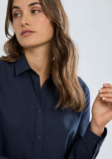 A women's long sleeve button-up shirt in navy blue with a collared neck and buttoned cuffs, featuring a slight texture.