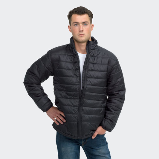 A unisex black puffer jacket with a zip closure and a stand collar, modelled by a man. Features a logo.
