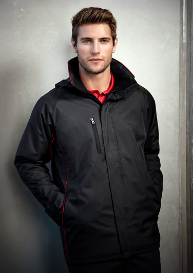 A man wearing a black unisex jacket with red accents and a zippered pocket, featuring a logo.